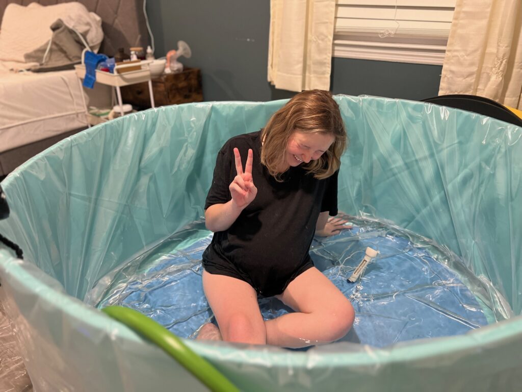 My Birth Story - me posing in the birth pool in early active labor before things got too tiring